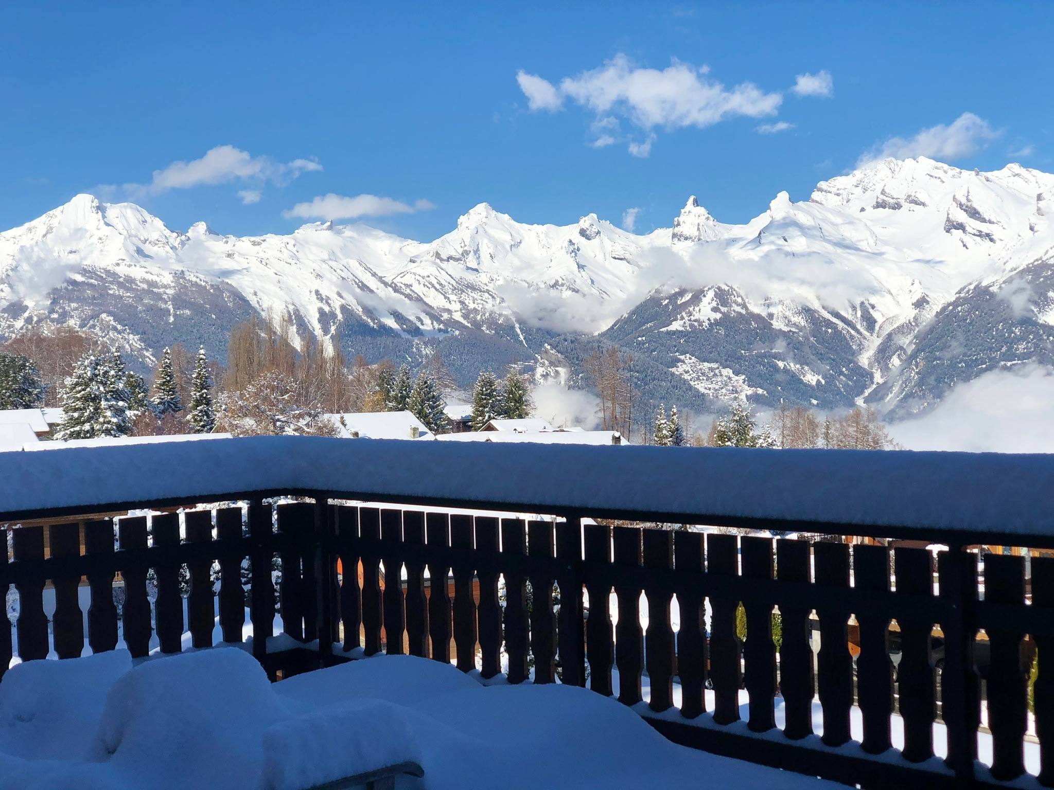 Snow-loaded balcony under blue sky